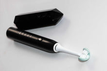 Load image into Gallery viewer, Water-resistant adult electric toothbrush on a bathroom counter
